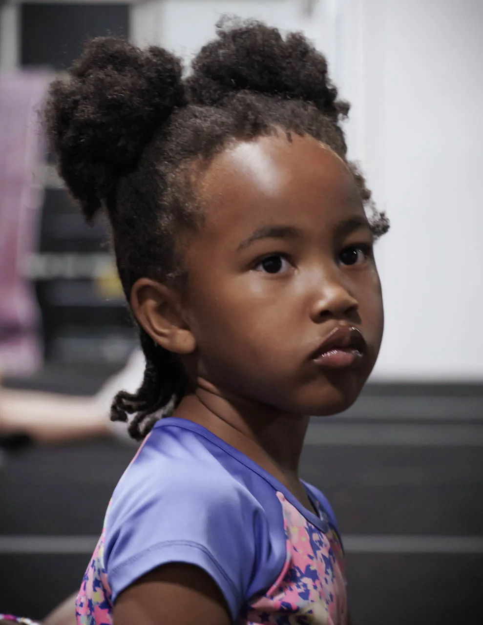 A young Category 5 athlete listening with focus